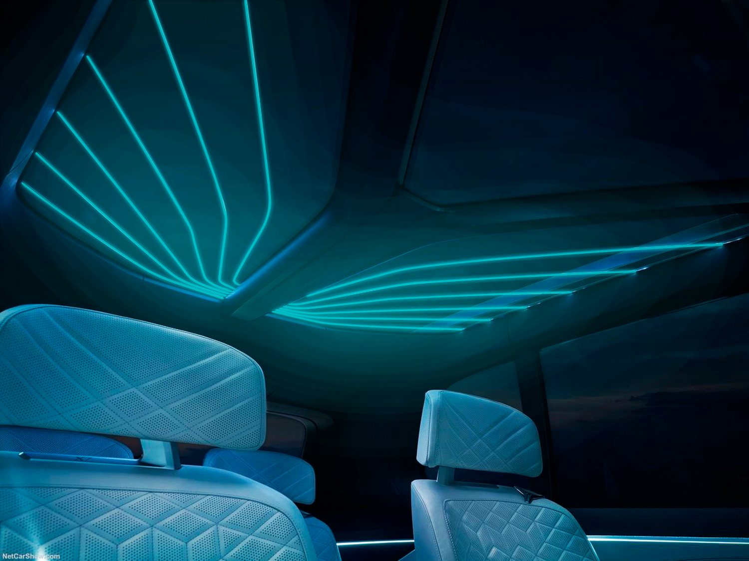 Vehicle interior at night, the headliner traced by fanning lines of turquoise bioluminescent light above pale quilted seats